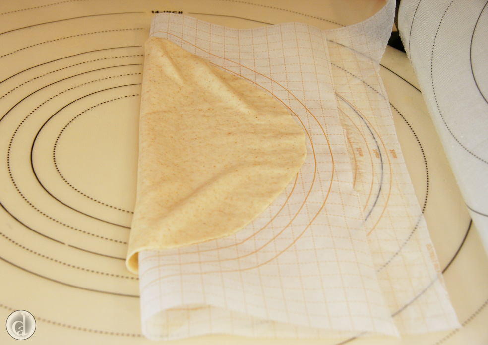 Peeling the dough off the mat